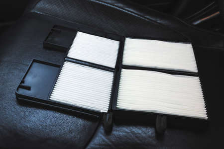 New car air filter on a leather black car seatの写真素材