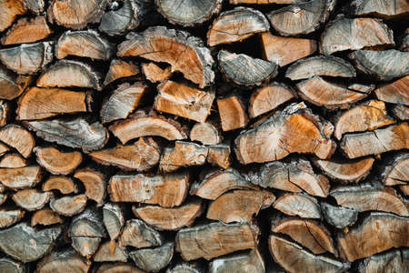 Woodpile. textured firewood background. Pile of old dry chopped firewood