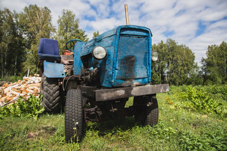 Old homemade funny tractor in the summer in the countrysideの写真素材