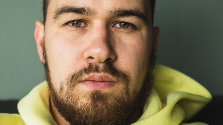 Face of a young man with untrimmed beard and mustache close-up. selective focusの写真素材