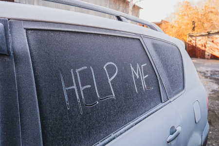 The text Help Me on the frozen glass of the carの写真素材