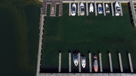 Aerial view of a marina with moored boats over green river bayの写真素材