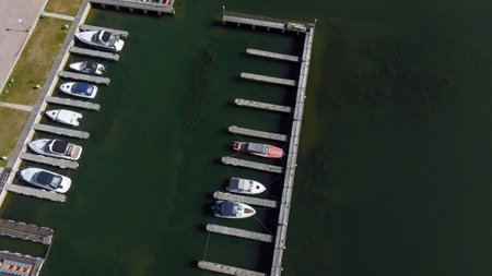 Aerial view of a marina with moored boats over green river bayの写真素材