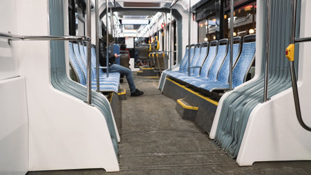Inside the tram in the evening. one passenger. Dirty floor at the end of the dayの写真素材