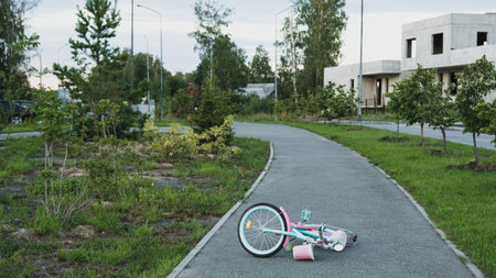Lonely children's bicycle lying on the road. summer timeの写真素材