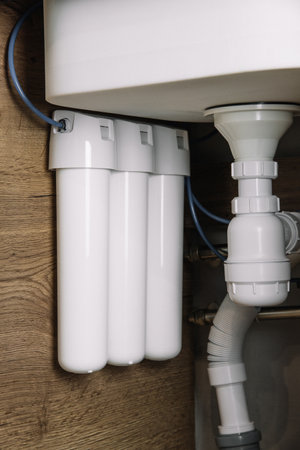 Home water filtration plant close-up. Small water filters under the sink in the kitchenの写真素材