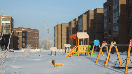 Snow covered deserted playground of residential buildings. Snowdrifts. Season specificの写真素材