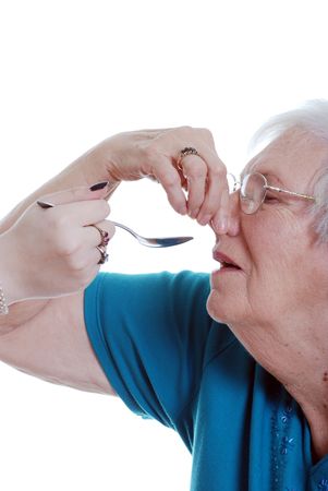 elderly woman unhappy taking medicationの写真素材