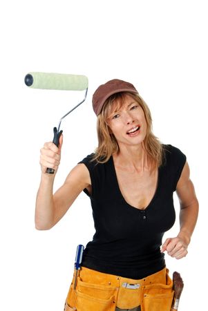 Angry female painter waving a paint rollerの写真素材