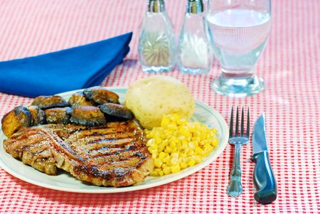 Barbecue T Bone steak with vegetables with cutleryの写真素材