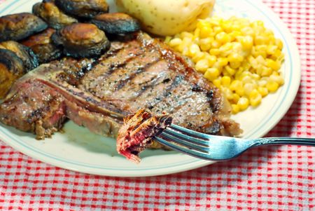 T Bone steak on a forkの写真素材