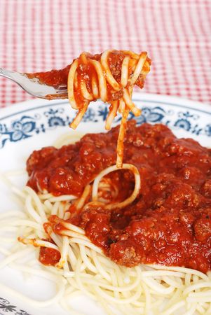 spaghetti and meat sauce on a forkの写真素材
