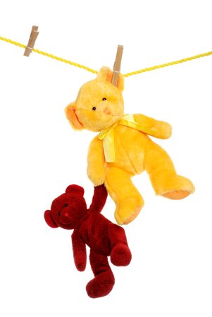 Teddy bear on clothes line rescuing anotherの写真素材