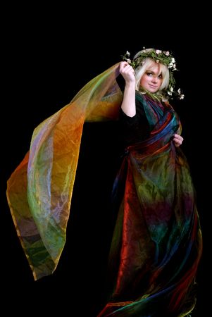 older woman dancing using colorful silk fabricの写真素材
