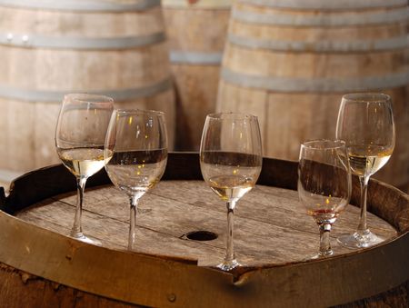 used wine glasses on an old wine barrel