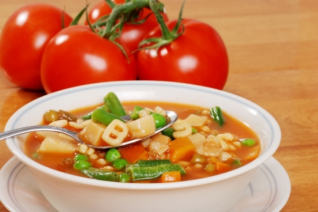 vegetable soup with tomato in the backgroundの写真素材