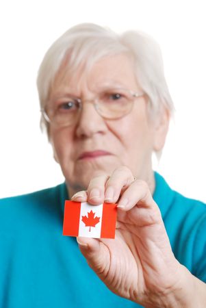 senior woman holding canada day flag focus on stickerの写真素材