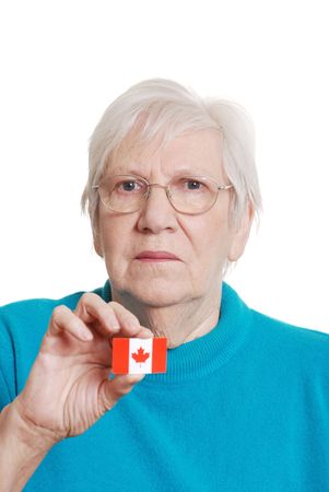 senior woman holding canada day flag sticker focus on faceの写真素材