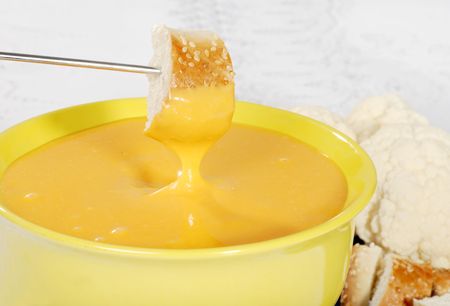 bread dipped in cheese fondueの写真素材