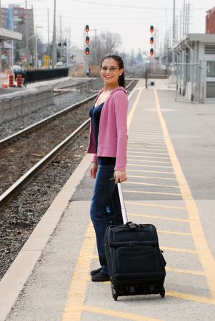 Happy woman waiting for a trainの写真素材