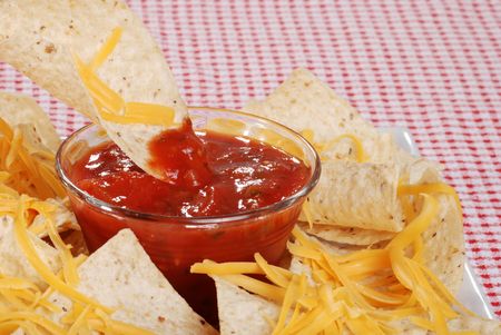 dipping nachos in salsaの写真素材