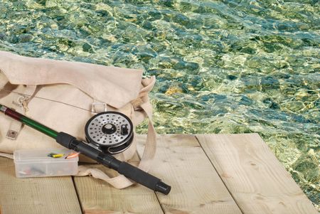 fly fishing equipment on a dockの写真素材