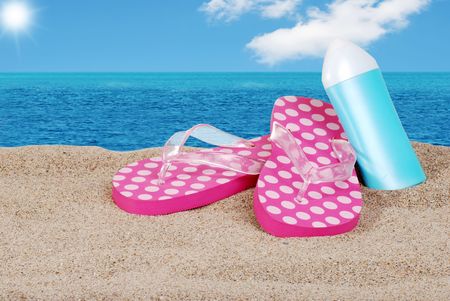 sandals and suntan lotion on a sunny dayの写真素材