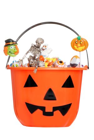 halloween pumpkin pail filled with candyの写真素材