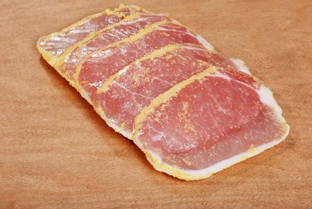 peameal bacon on wood cutting boardの写真素材
