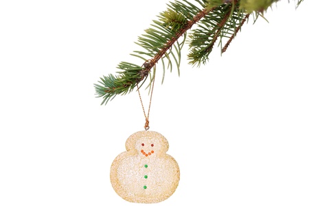 snowman cookie hanging on christmas tree branchの写真素材