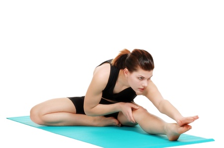 young woman doing stretching excersiseの写真素材