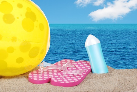 beachball sandals and suntan lotionの写真素材