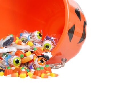 macro spilled halloween candy and pumpkin bucketの写真素材