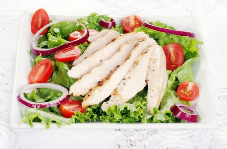 plate of grilled chicken saladの写真素材