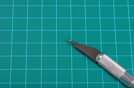 green cutting mat with knifeの写真素材