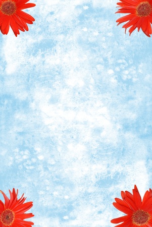 red Gerbera Daisies in the corners with blue watercolor paperの写真素材