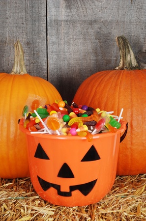 candy filled halloween pumpkin bucketの写真素材
