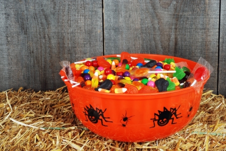 bowl of halloween candy on strawの写真素材