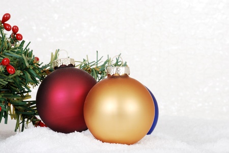 Christmas ornaments in snowの写真素材