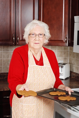 senior woman with gingerbread snowmanの写真素材