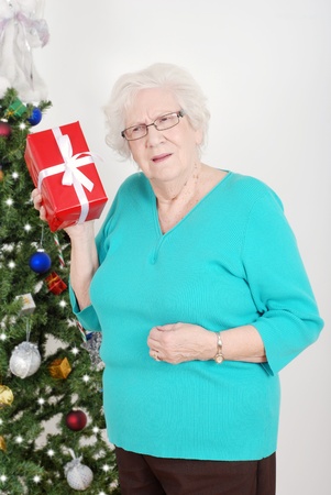 Senior woman guessing her christmas giftの写真素材