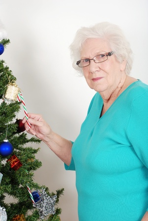 Senior woman stealing candy caneの写真素材