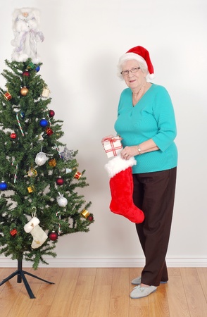 Senior woman with santa hat and stockingの写真素材