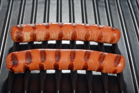 two hotdogs on a grillの写真素材