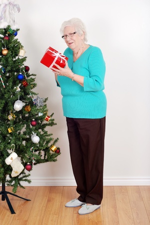 Happy senior woman with christmas giftの写真素材