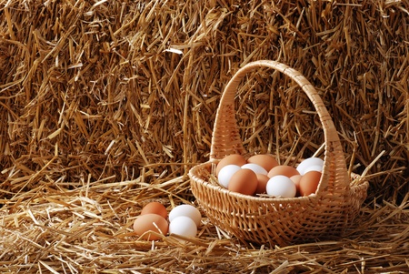 Brown and white eggs in a basketの写真素材