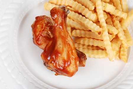 barbecue chicken legs with french friesの写真素材