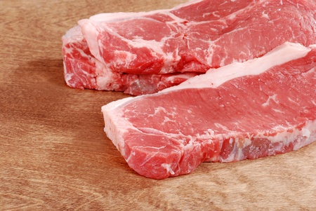 Strip loin steak on woodの写真素材