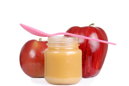 baby jar with apple sauce and pink spoonの写真素材