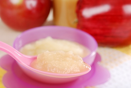 Macro baby apple sauce on a spoonの写真素材